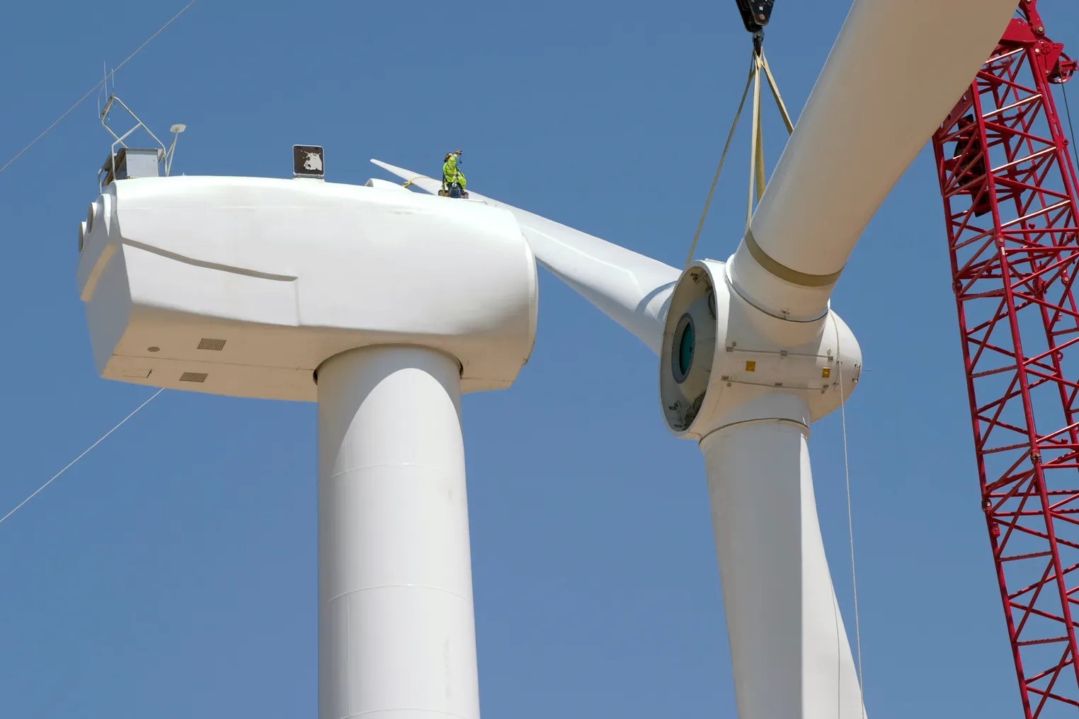 Workers assemble a wind turbine.