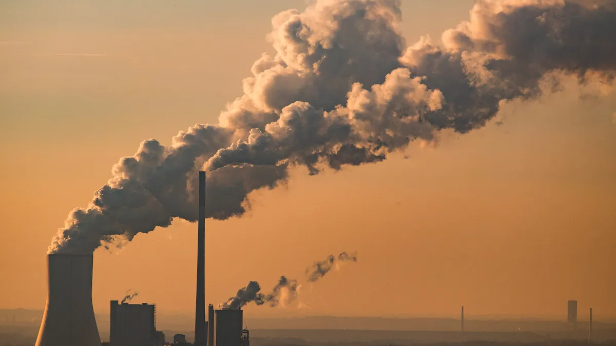 Steam and exhaust rise from a power plant.